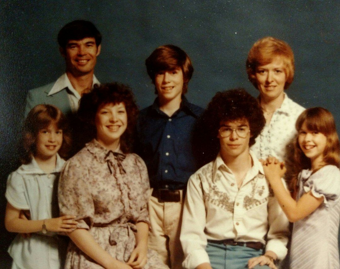 Diverse team of broadcast professionals standing together in a studio